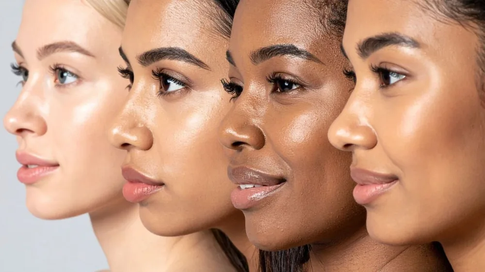 Four women with different skin tones showing diverse skin types