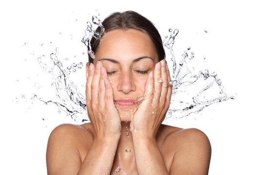 Woman splashing water on face